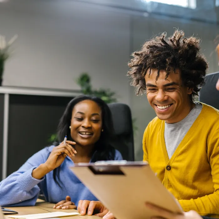 Two people at work looking at a laptop