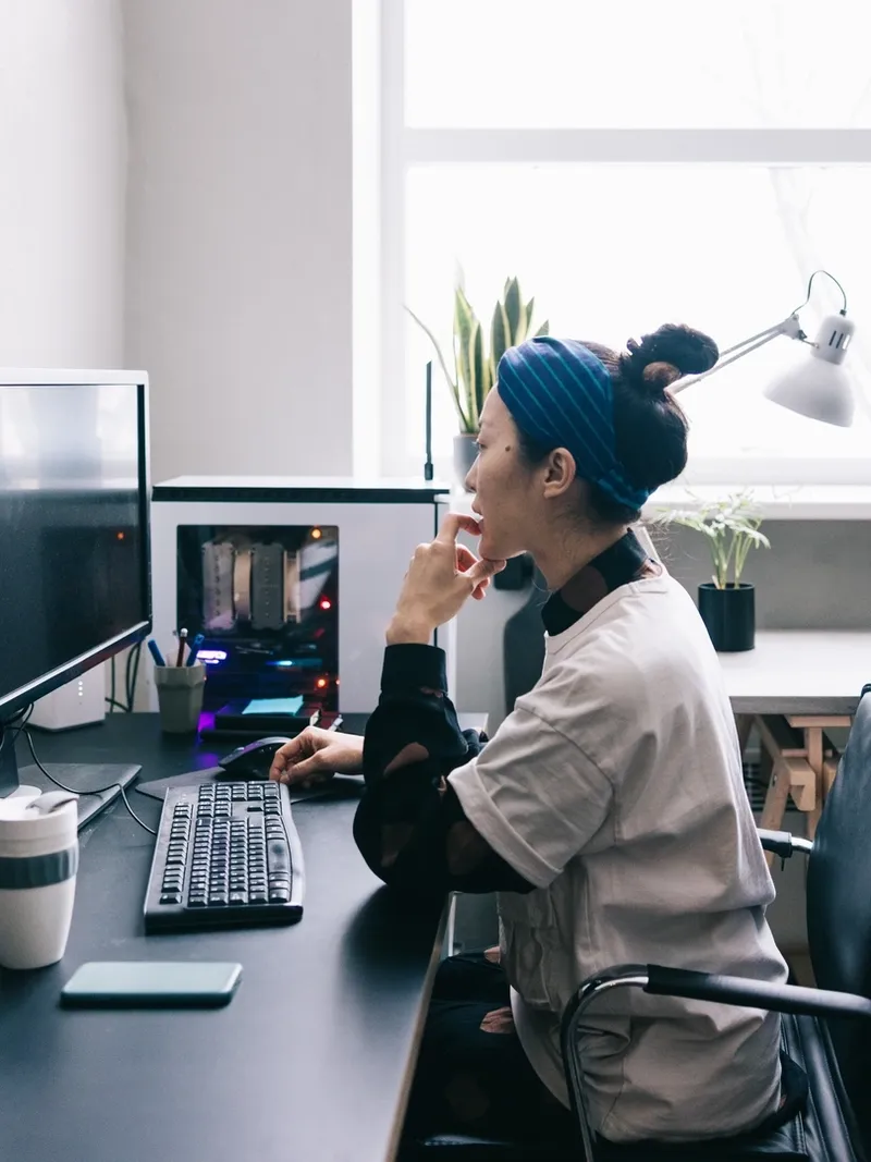 Japanese computer programmer working on new software at the office.