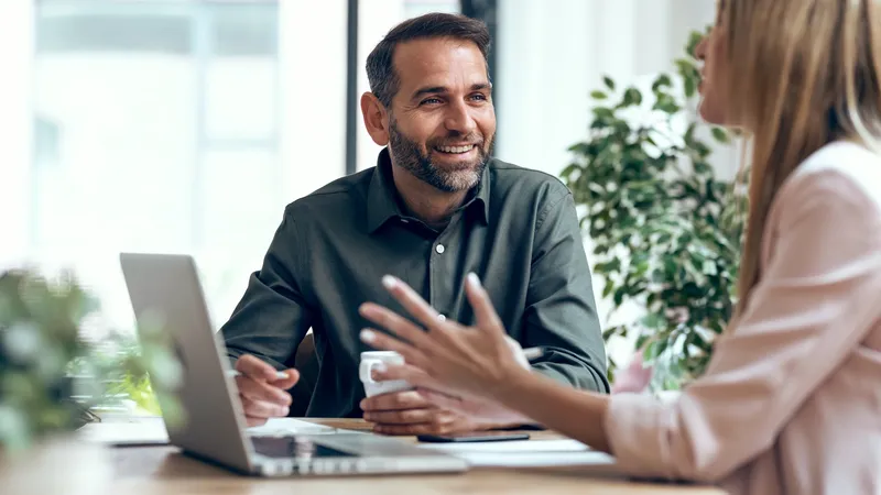 business people working together with laptop while talking in the coworking place. 