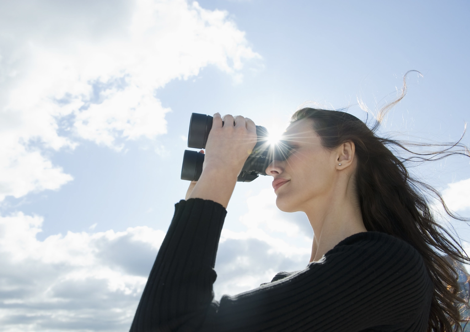 Woman looking through binoculars