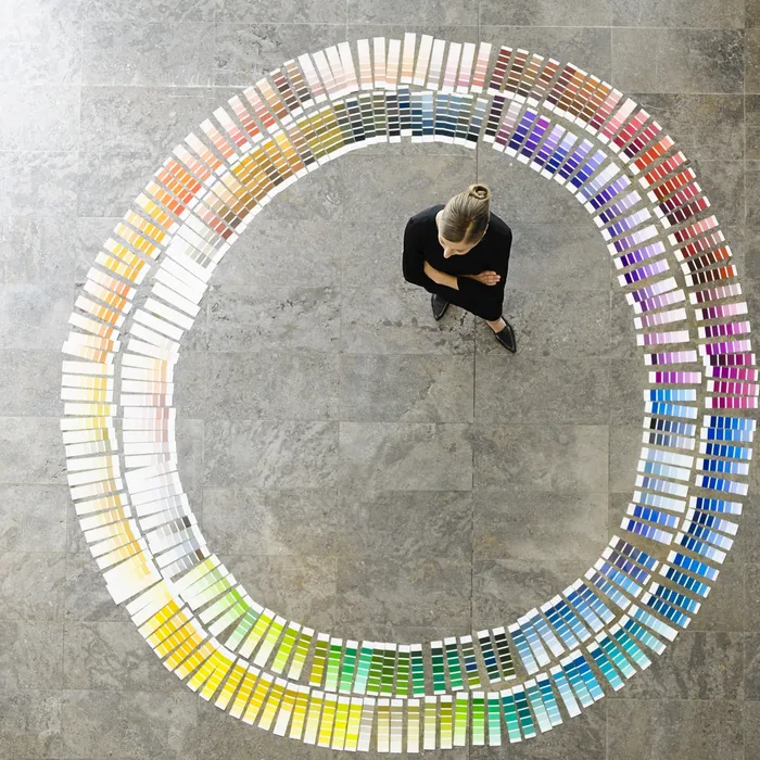 Businesswoman examining paint swatches