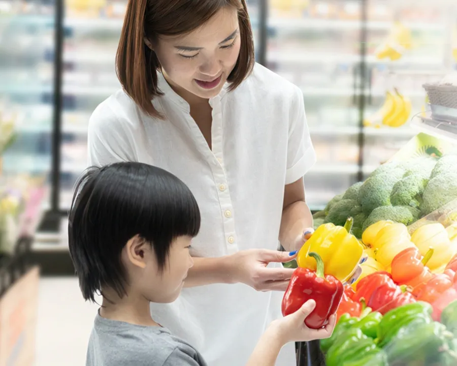 Woman and child looking at vegitables