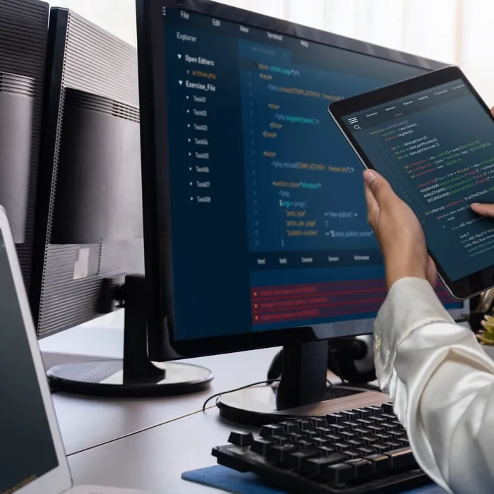 Software development team working together in office, coding script display on computer monitor. Programmer and software engineer working in tech developer company. Trailblazing