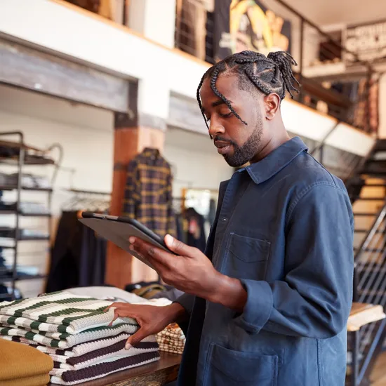 Male,Owner,Of,Fashion,Store,Using,Digital,Tablet,To,Check