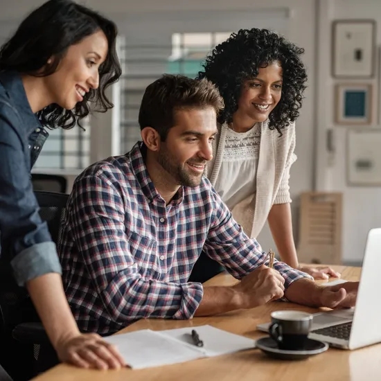 Three office colleagues collaborating on a project.
