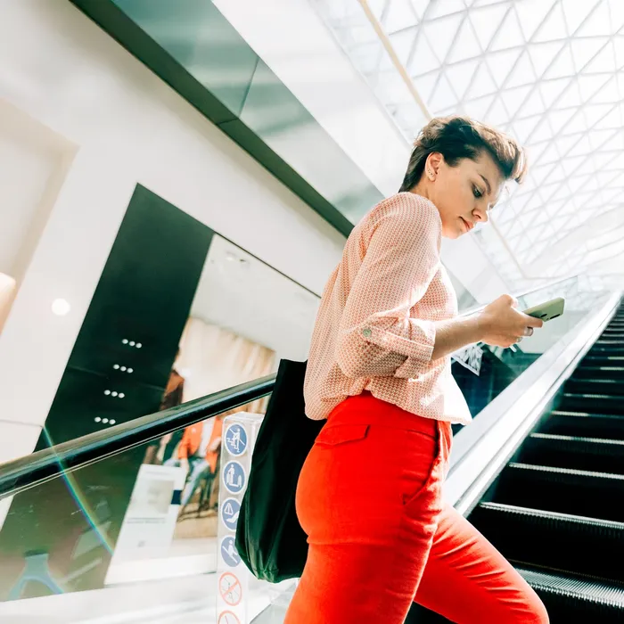 Woman uses a phone while at the mall, business center, airportColorful Human