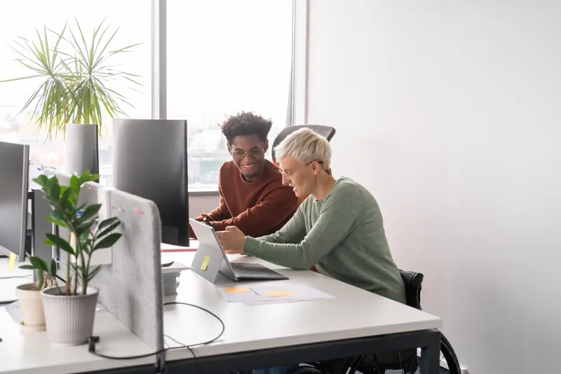 Woman and a man with a laptop and tablet