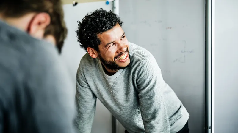 Portrait of a casual afro-american businessman during a  meeting. He's smiling to his colleague