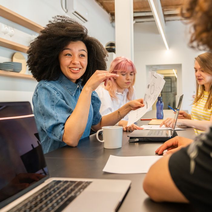 A group of women with laptops having a meeting