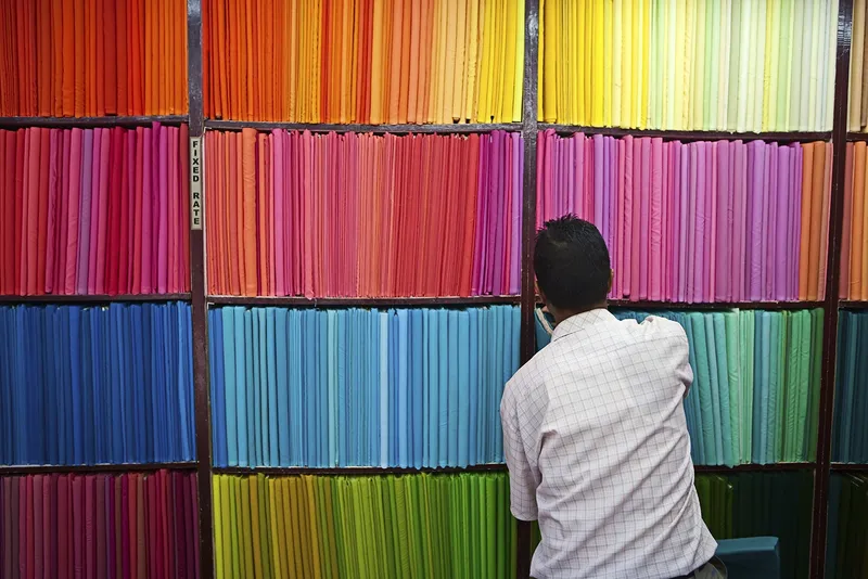 A man arranges colorful folders and documents