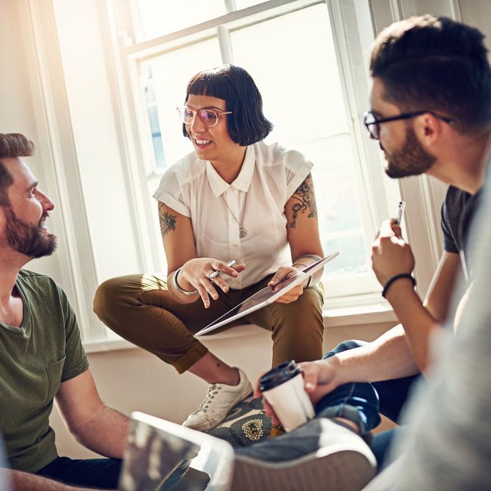 Shot of a team of designers brainstorming together in their office