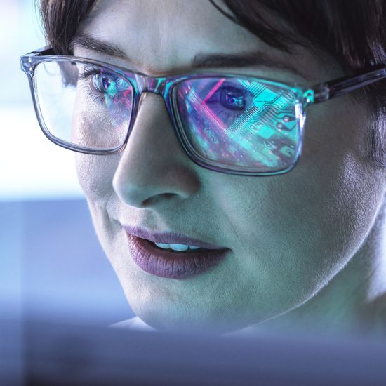 AI Engineering, Female STEM engineer using artificial intelligence to design micro electronics in the labColorful Human