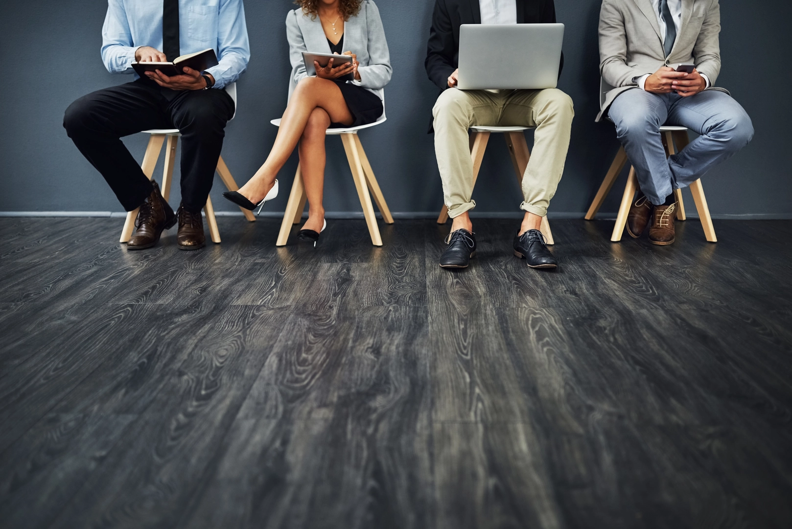 Cropped shot of a group of unrecognisable businesspeople waiting in line for a job interview