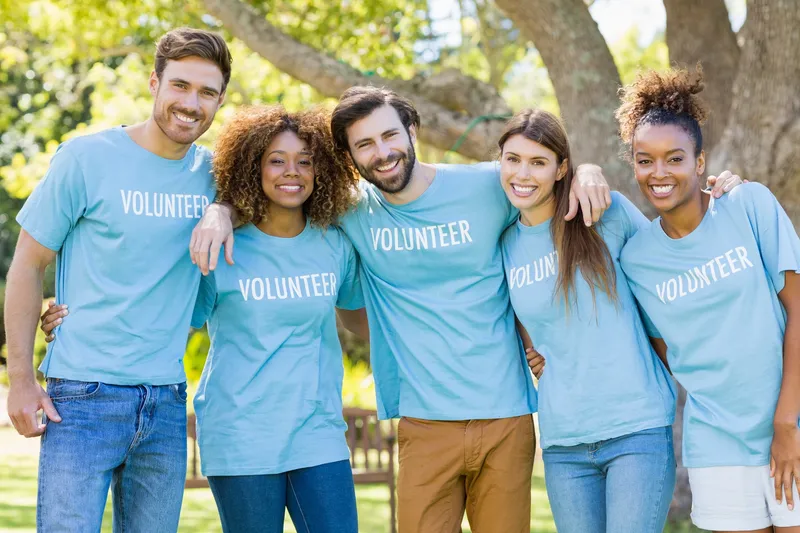 Portrait Of Volunteer Group Posing In Park