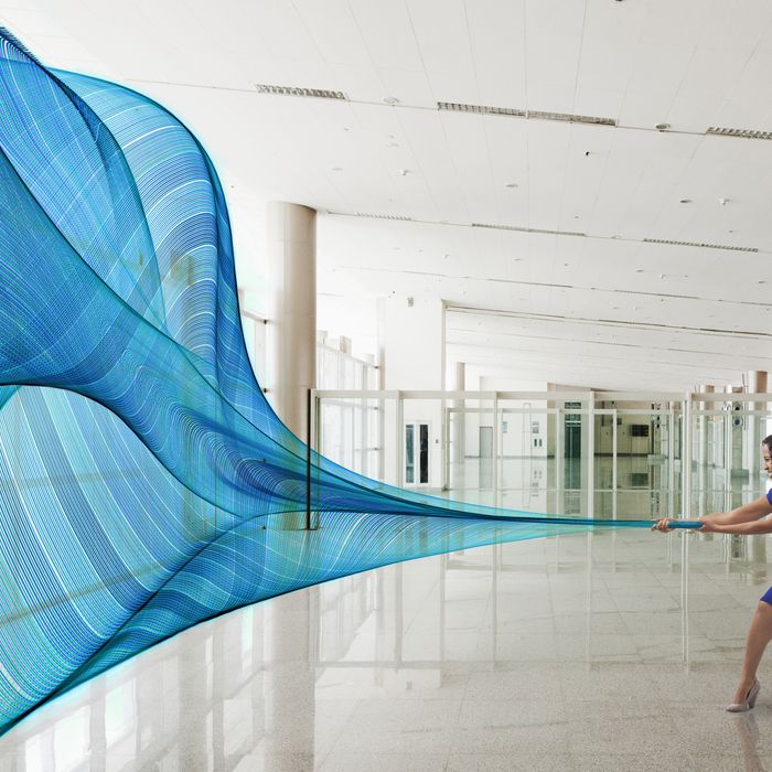 Mixed Race businesswoman pulling blue data waves