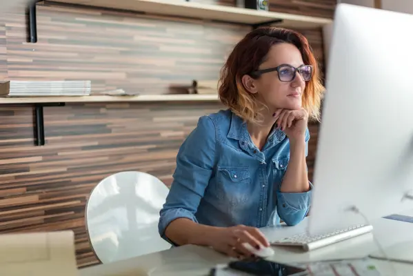 Businesswoman looking at a computer in an office.