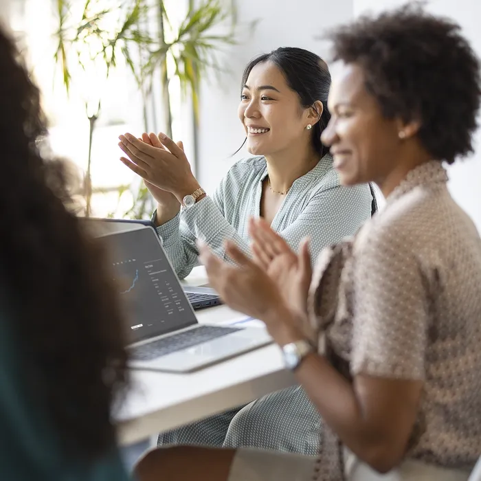 Successful business team is clapping their hands, celebrating the performance of new product