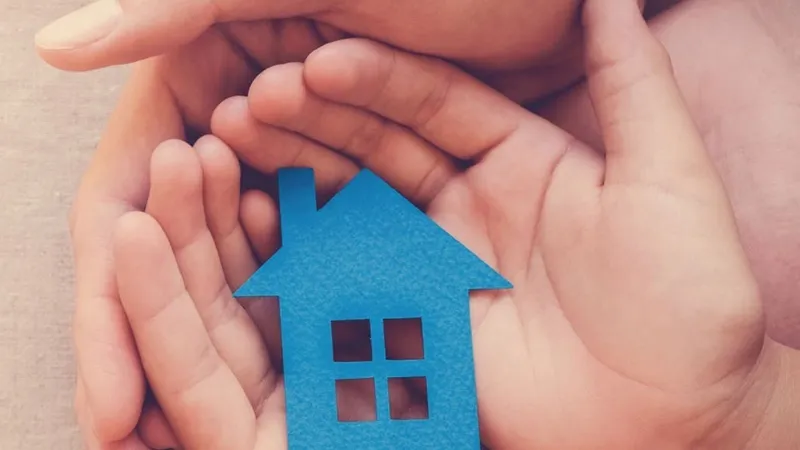 hands are protecting house