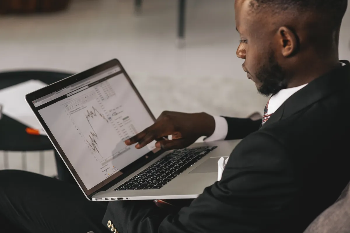 Black,Businessman,Using,Laptop,For,Analyzing,Data,Stock,Market,,Forex