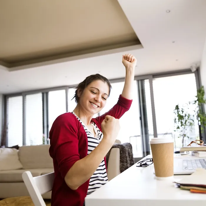 Happy woman at desk at home