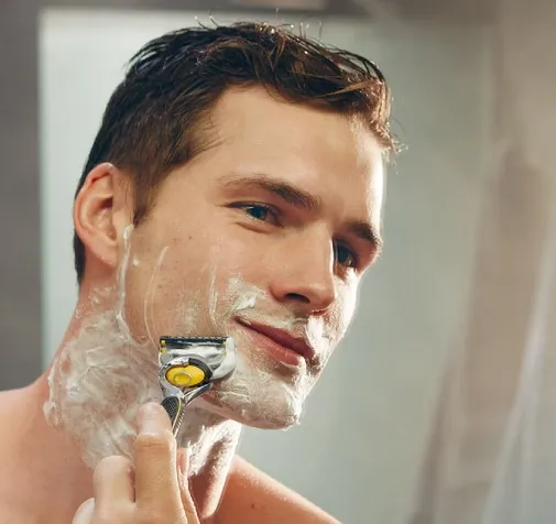 Man shaving his beard - Hero image