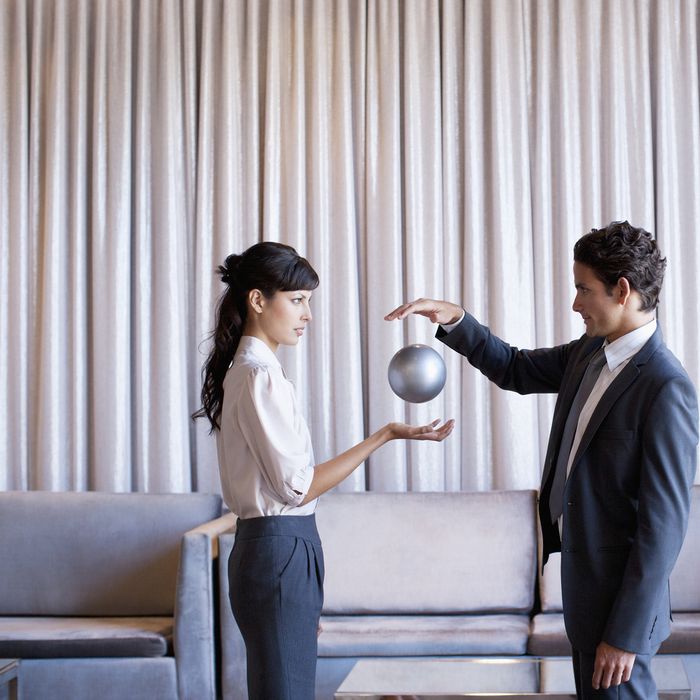 Business people high-fiving in hotel lobby