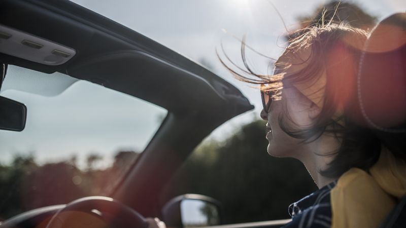 Woman driving convertible car
