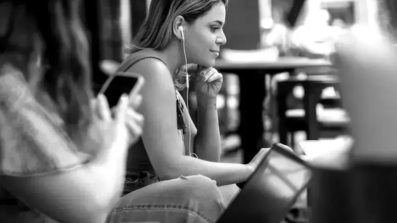 Black and white image of a woman listening to music