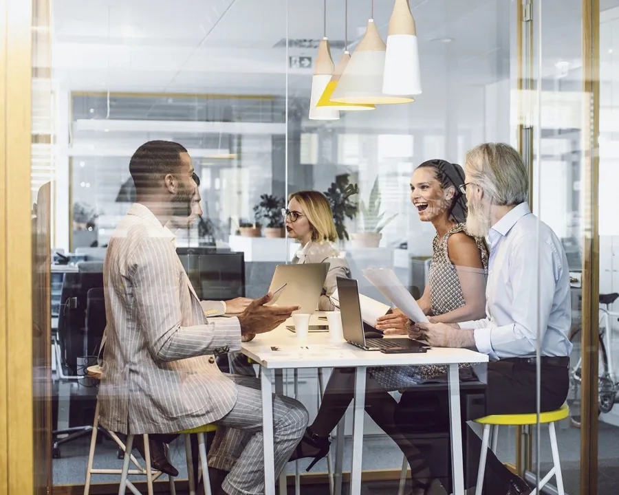smiling people talking in office
