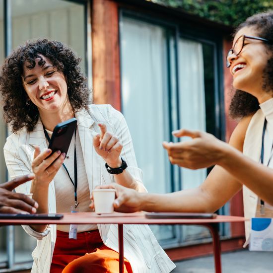 Casual outdoor business meeting with a trio of professionals enjoying a conversation. Showcases teamwork, communication, and collaboration in a relaxed atmosphere.Colorful Human