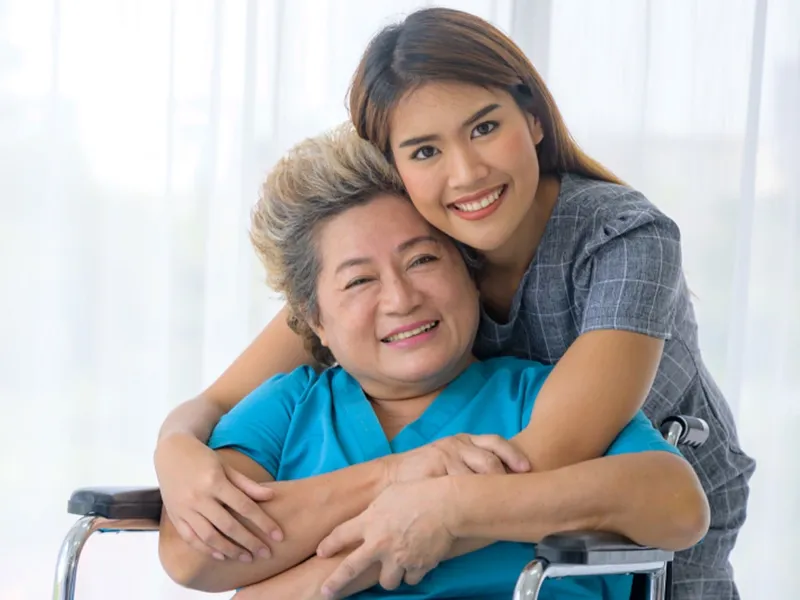 Woman hugging an elder woman