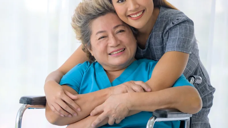 Woman hugging an elder woman