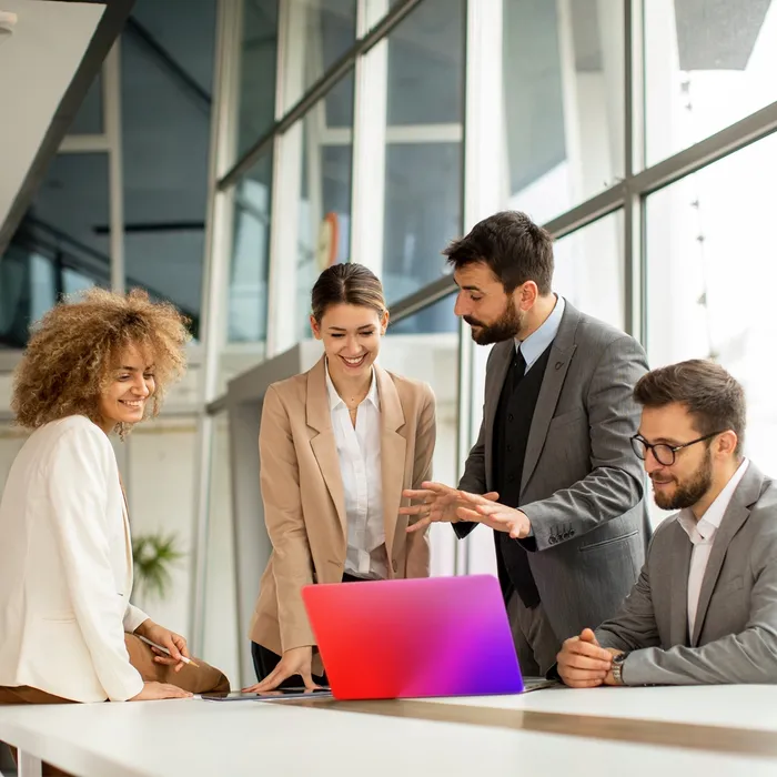 People looking at a laptop smiling
