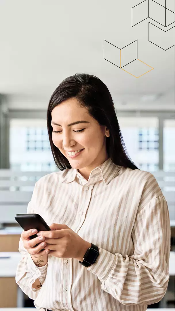 Smiling young woman looking at cell phone