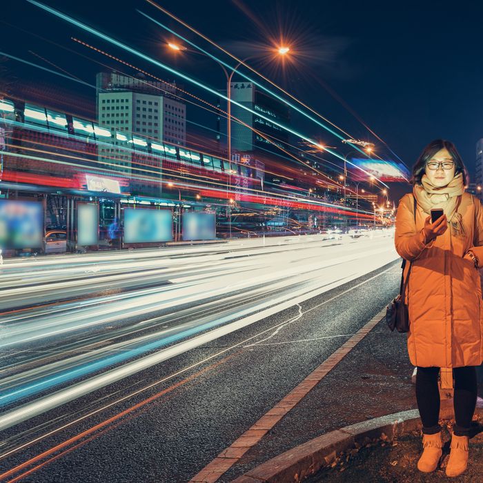 Woman using Smart Phone in urban city