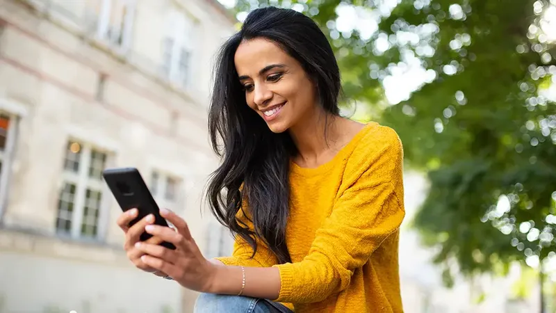 Woman looking at a smartphone and smiling