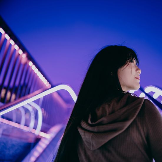 Low angle view of woman riding escalatorColorful Human