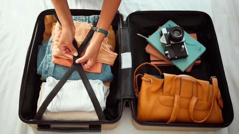 Travel,Suitcase,,Bedroom,And,Hands,Of,Woman,Packing,For,Europe