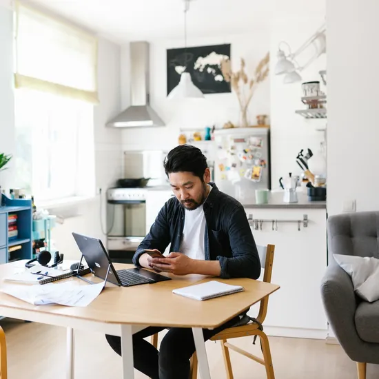 Photo series of japanese man working from home as a freelancer, making conference calls and discussing projects.