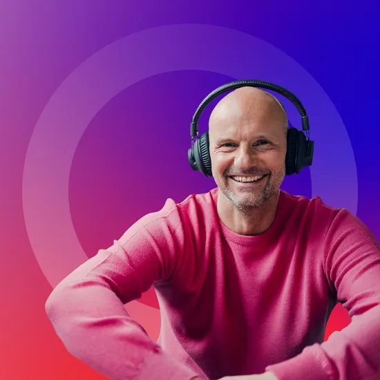 Man with headphones smiling on a gradient background