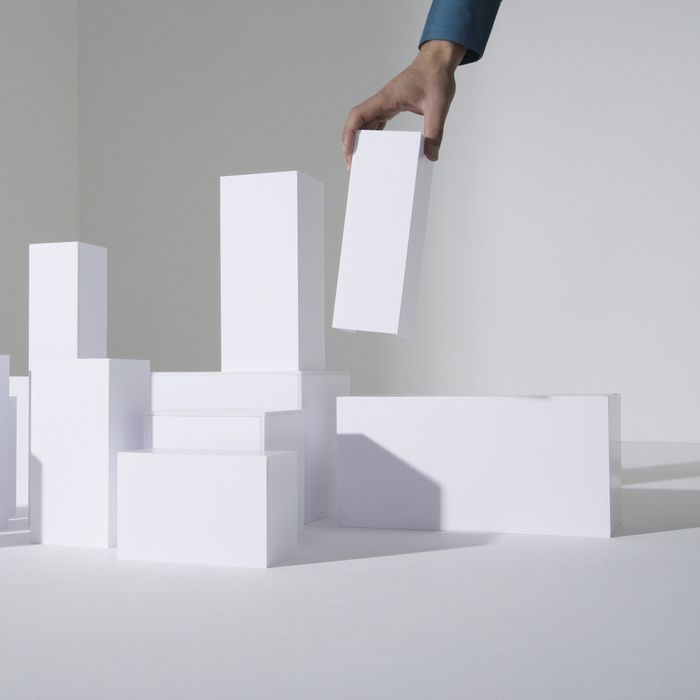 Man building white blocks, close-up