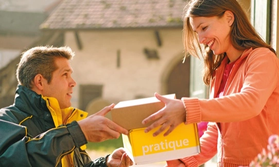 a delivery man delivering parcel to a lady