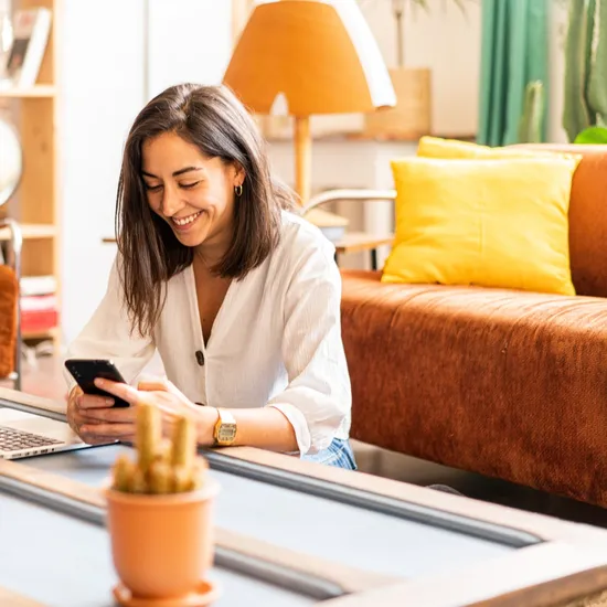 Woman with laptop on her phone