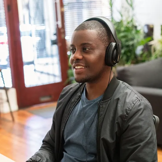 Man on headphones at his desk