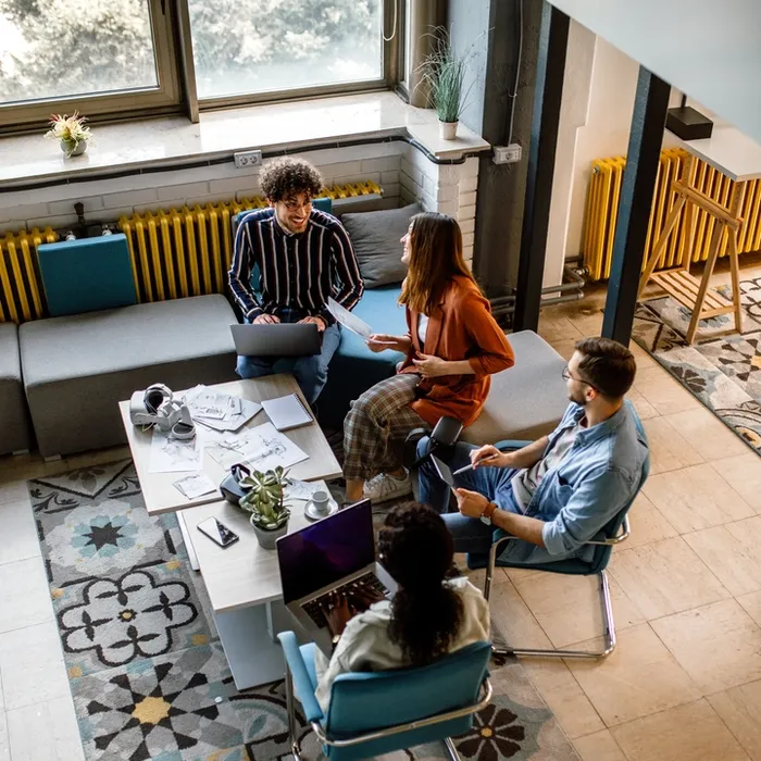 Business team of sucessful colleagues having morning meeting in the office, checking to do tasks.Colorful Human