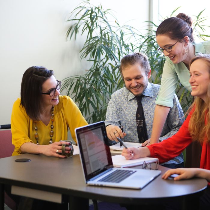 Co-workers collaborating around a table