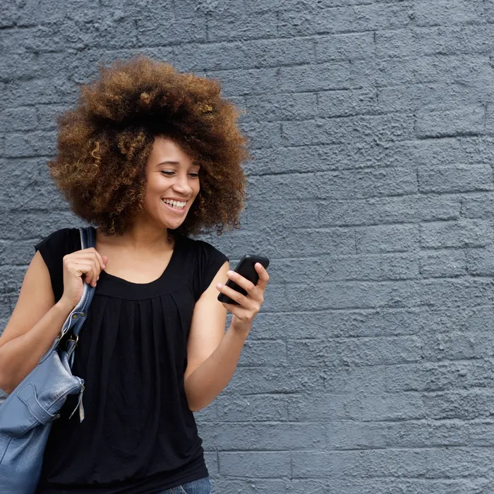 Portrait of smiling woman with cell phone