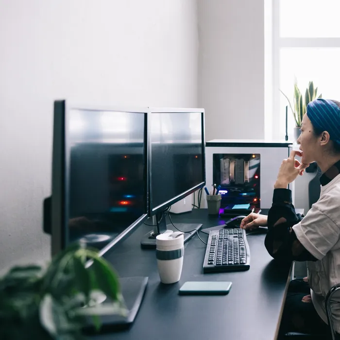 Japanese computer programmer working on new software at the office.