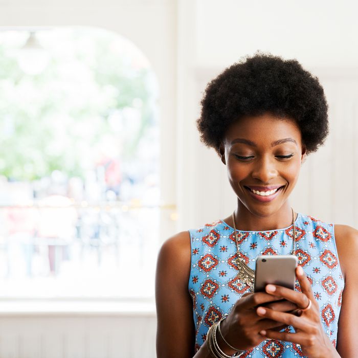 Woman smiling using smart phone