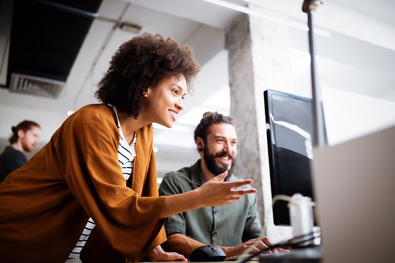 Woman looking at computer screen with a man next to her